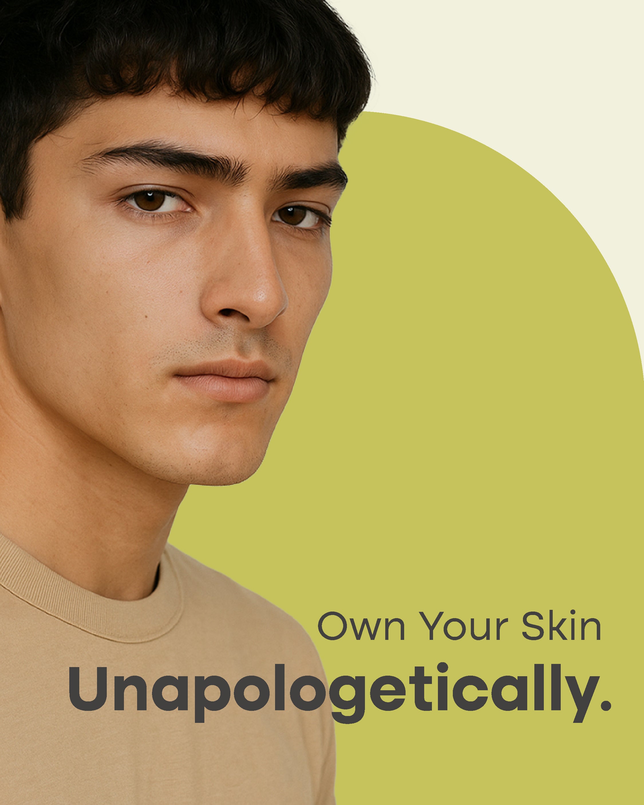 Man wearing a beige shirt with text 'Own Your Skin Unapologetically' on a green background