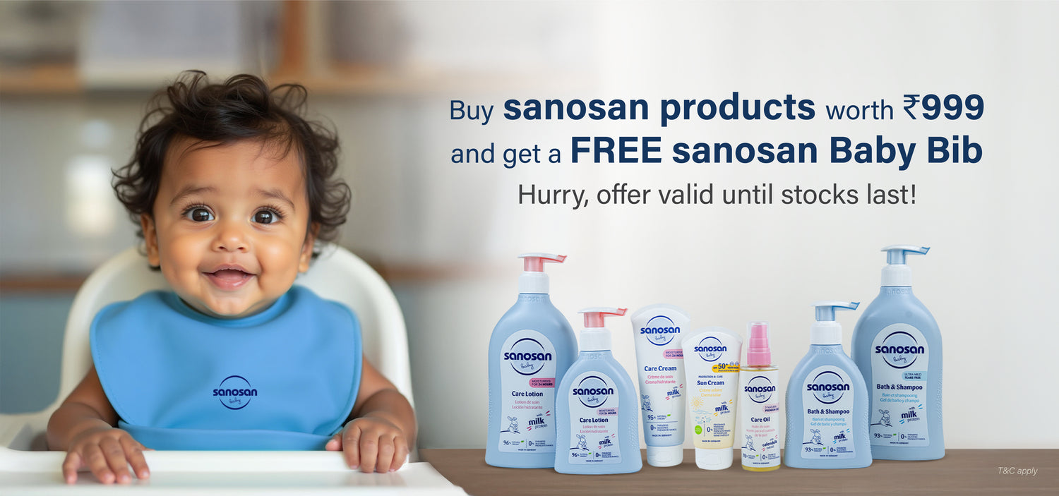 Baby wearing a blue sanosan baby bib