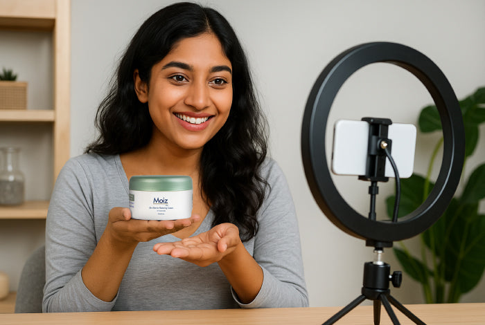 Woman holding a jar of Moiz skincare product in front of a camera setup.